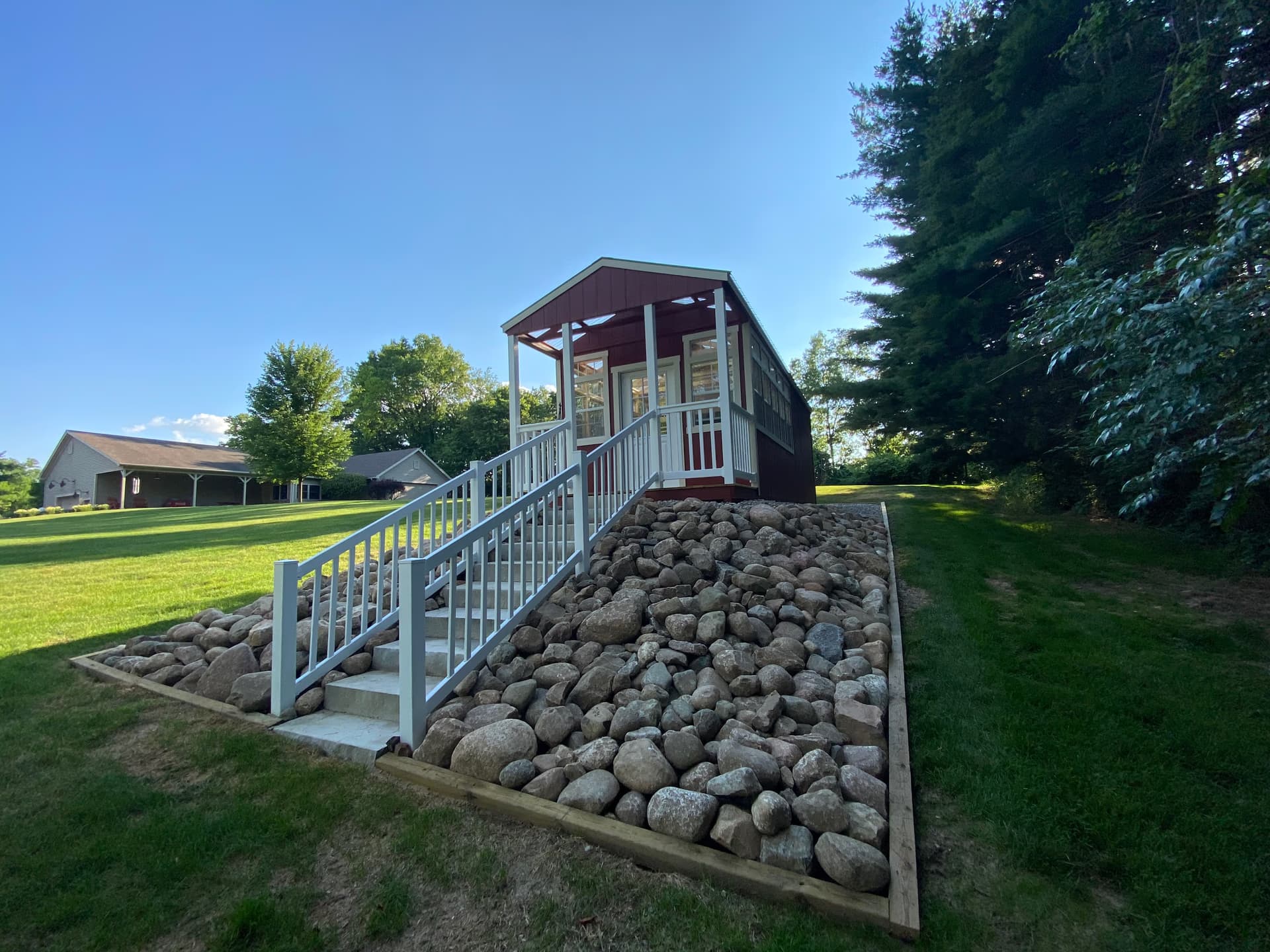Red Amish-built cabin on stone pad at customer property in Southern Michigan