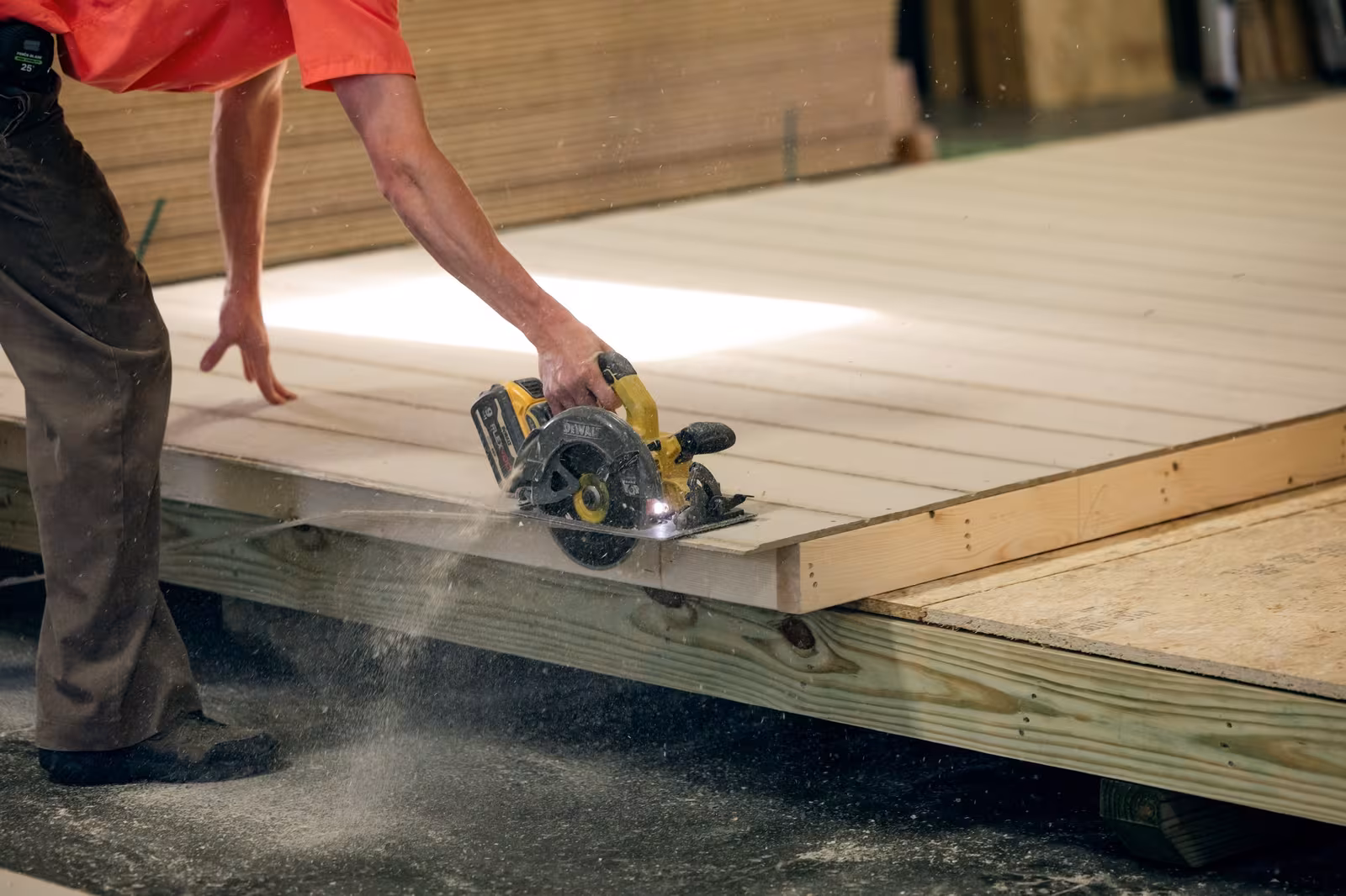 An Amish builder cutting a shed floor panel with a circular saw
